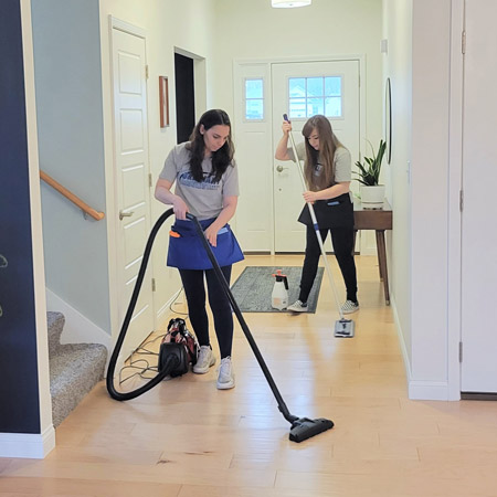 Brilliant Results cleaning professionals cleaning floor with vacuum and mop